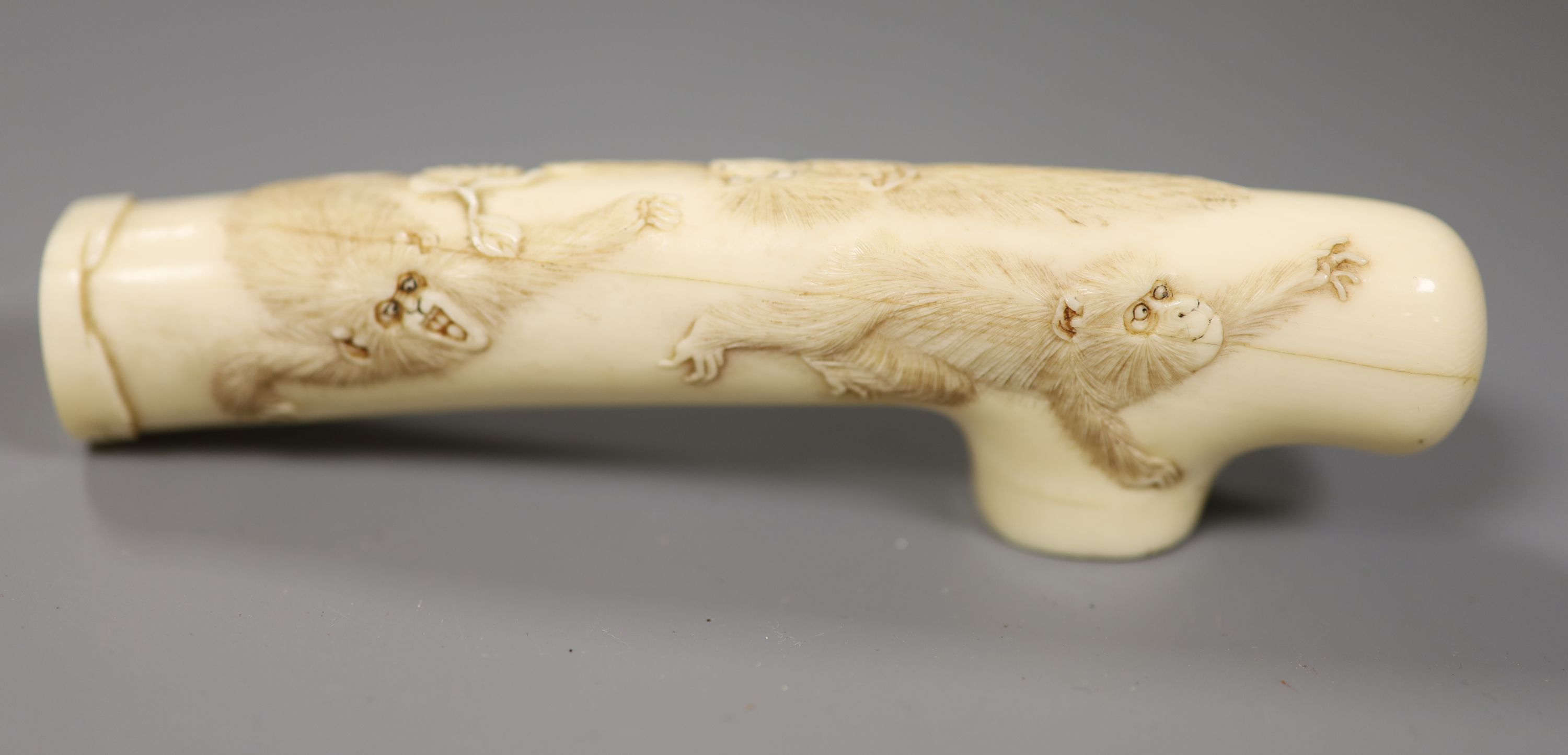 A Japanese Meiji period carved ivory cane handle